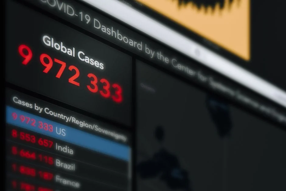 Focused image of hands analyzing business graphs and charts in a folder, highlighting data insights.